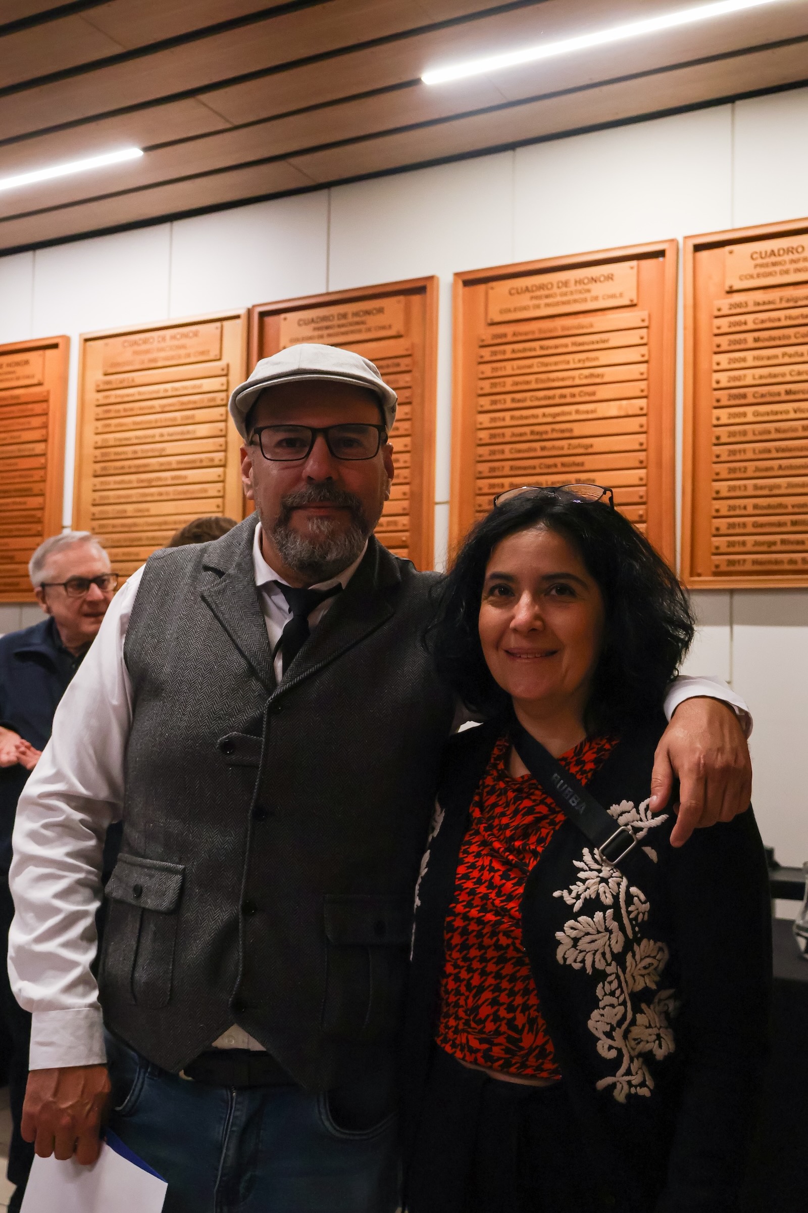Hombre y mujer frente a los Cuadros de Honor